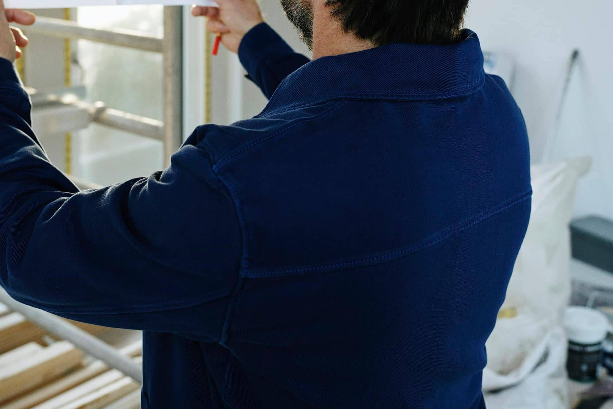 A tradesman checking plans on site